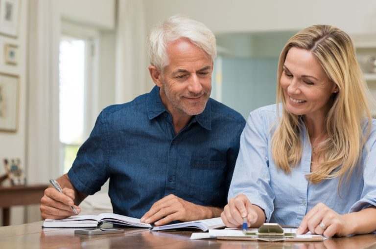 mature couple at home making a budget plan
